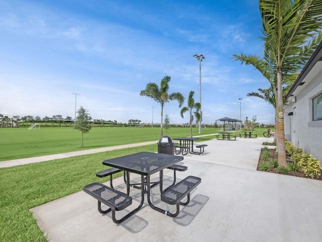 view of community with a gazebo, a lawn, and a patio