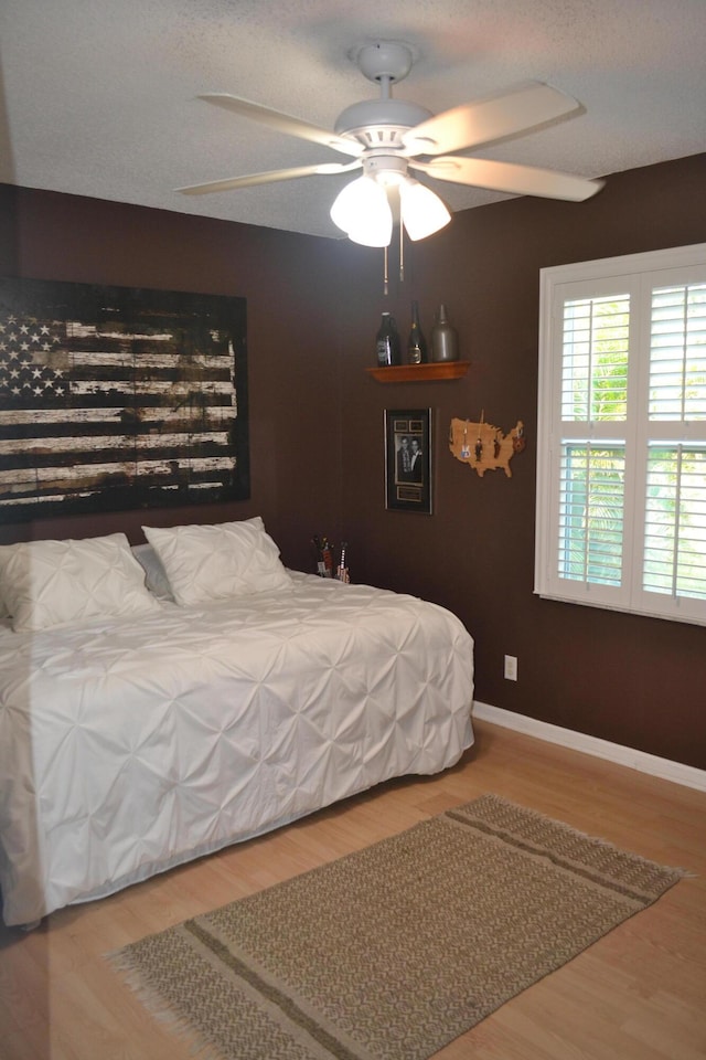 bedroom featuring ceiling fan and hardwood / wood-style flooring