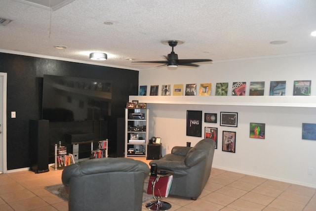 living room with ceiling fan, light tile patterned floors, and a textured ceiling