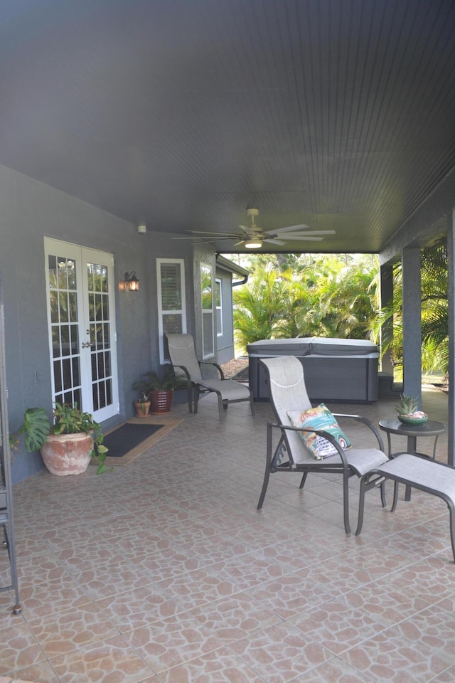 view of patio with a hot tub, ceiling fan, and french doors