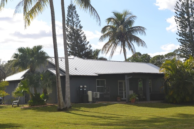 back of property featuring a lawn