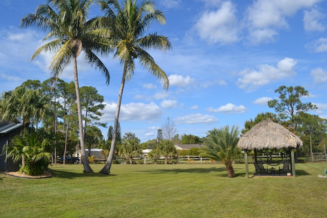 surrounding community with a gazebo and a yard