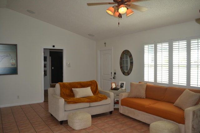 living room with ceiling fan, a textured ceiling, tile patterned floors, and vaulted ceiling