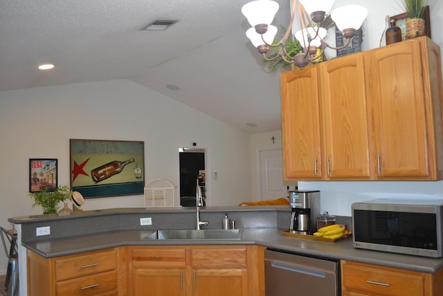 kitchen with a textured ceiling, appliances with stainless steel finishes, lofted ceiling, sink, and a notable chandelier