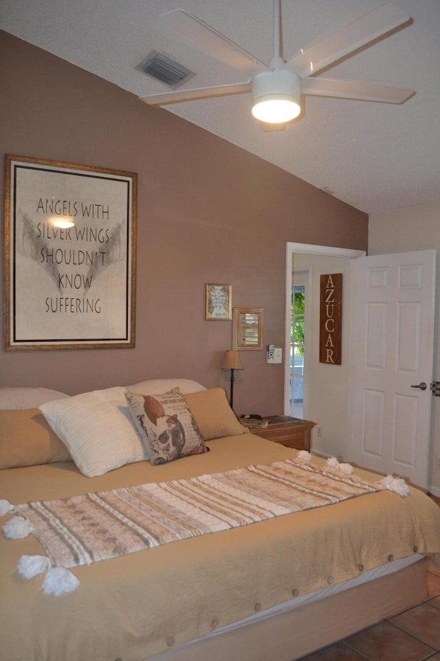 bedroom featuring ceiling fan, tile patterned floors, and lofted ceiling