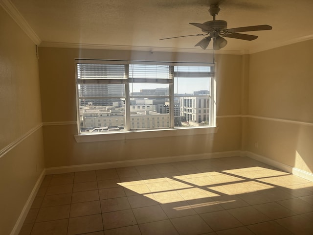 unfurnished room with tile patterned floors, ceiling fan, and crown molding