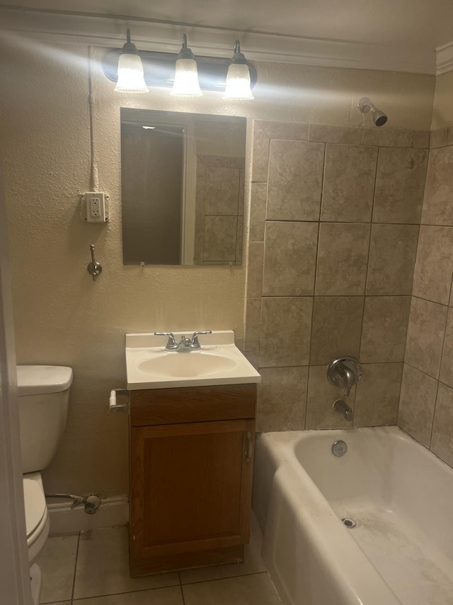 full bathroom with tile patterned floors, vanity, tiled shower / bath combo, crown molding, and toilet