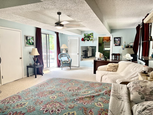 carpeted living room featuring a textured ceiling and ceiling fan