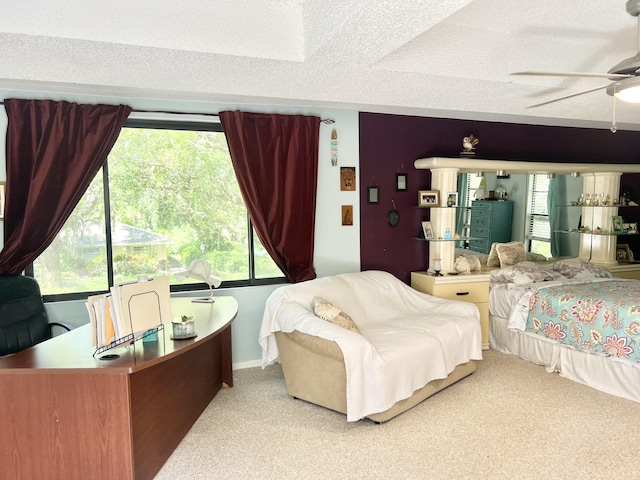 carpeted bedroom with a textured ceiling and ceiling fan