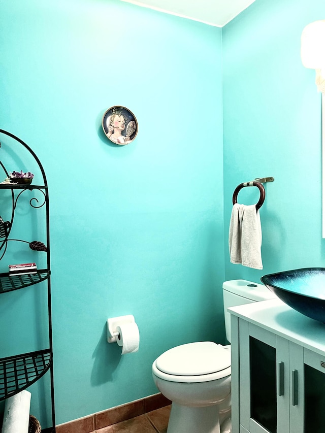 bathroom with tile patterned flooring, vanity, and toilet