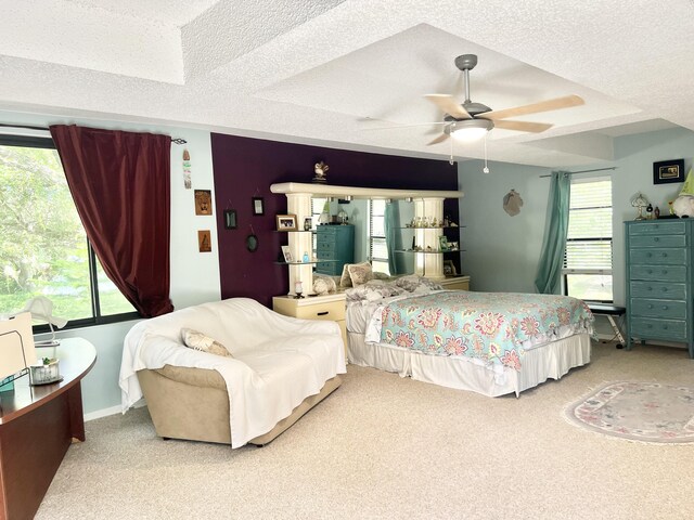 tiled living room featuring ceiling fan and a textured ceiling