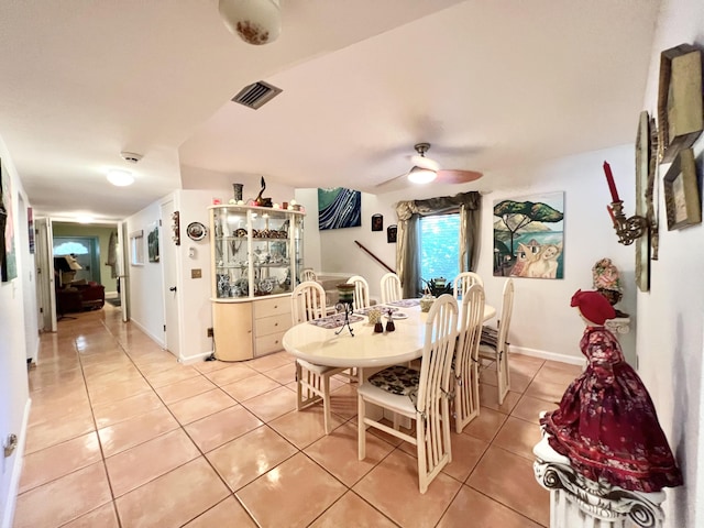 tiled dining room with ceiling fan