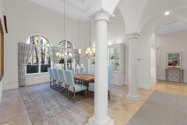 dining space with a high ceiling, ornate columns, ornamental molding, and a notable chandelier