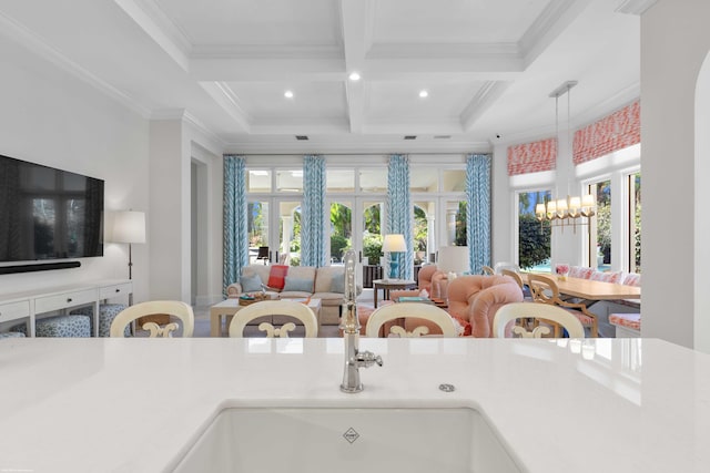 kitchen with beam ceiling, french doors, coffered ceiling, crown molding, and pendant lighting