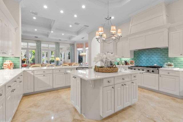 kitchen featuring beam ceiling, stainless steel appliances, coffered ceiling, kitchen peninsula, and decorative light fixtures