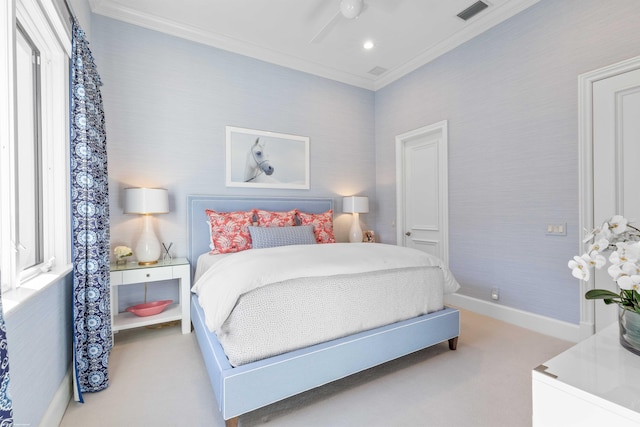 carpeted bedroom with ceiling fan and ornamental molding