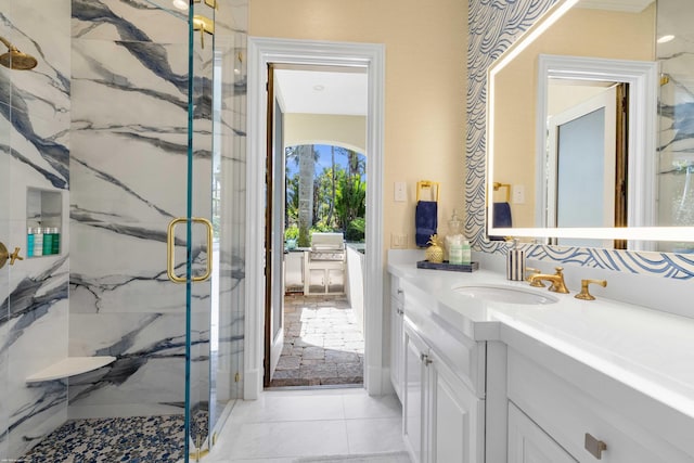 bathroom featuring tile patterned flooring, vanity, and walk in shower