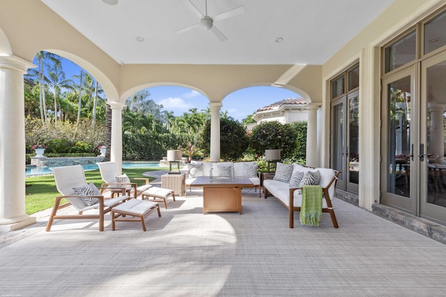 view of patio / terrace with an outdoor living space, ceiling fan, and french doors