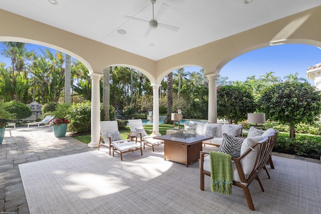 view of patio with an outdoor living space and ceiling fan