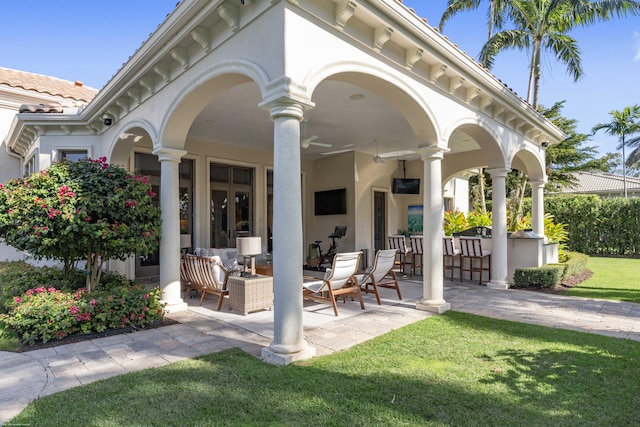 exterior space featuring a lawn, an outdoor bar, and a patio