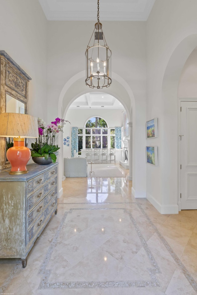 foyer entrance featuring a notable chandelier and a towering ceiling