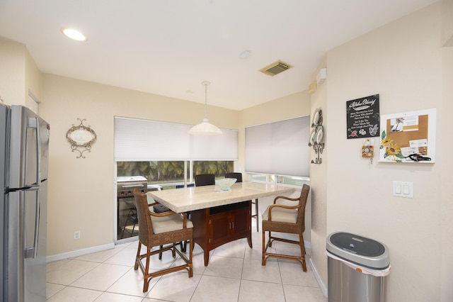 dining space featuring light tile patterned floors