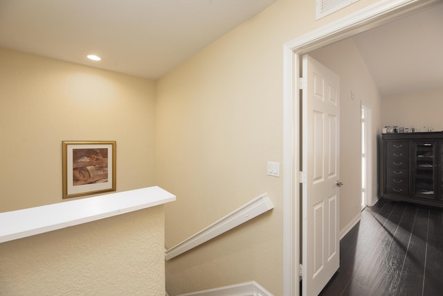 hall featuring lofted ceiling and dark hardwood / wood-style floors