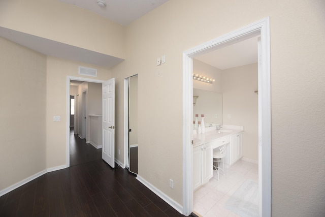 hall with hardwood / wood-style flooring and sink