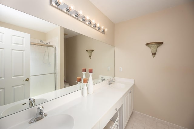 bathroom with an enclosed shower, vanity, tile patterned flooring, and toilet