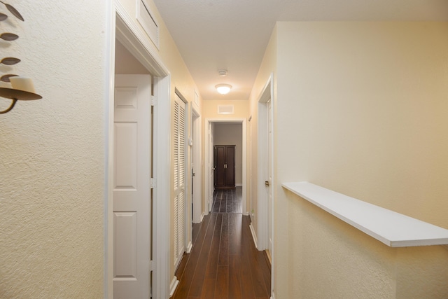 corridor with dark hardwood / wood-style floors