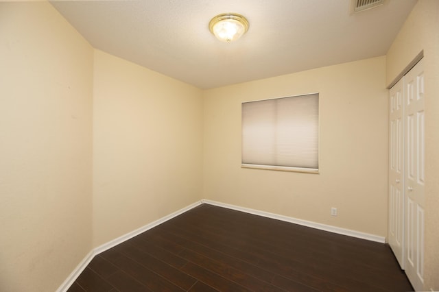 spare room with dark hardwood / wood-style floors