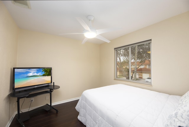 bedroom with ceiling fan and dark hardwood / wood-style flooring