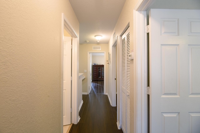 corridor with dark hardwood / wood-style floors