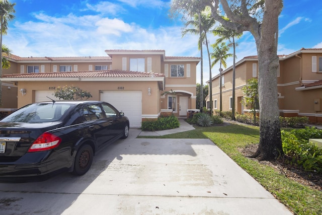 view of front of property featuring a garage and a front yard