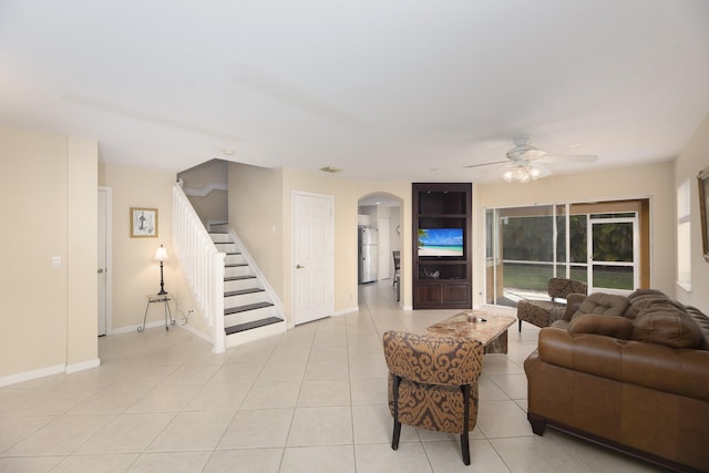 living room featuring ceiling fan and light tile patterned flooring