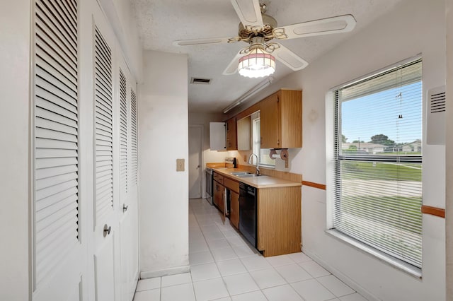 kitchen with dishwasher, sink, range with electric stovetop, light tile patterned flooring, and ceiling fan