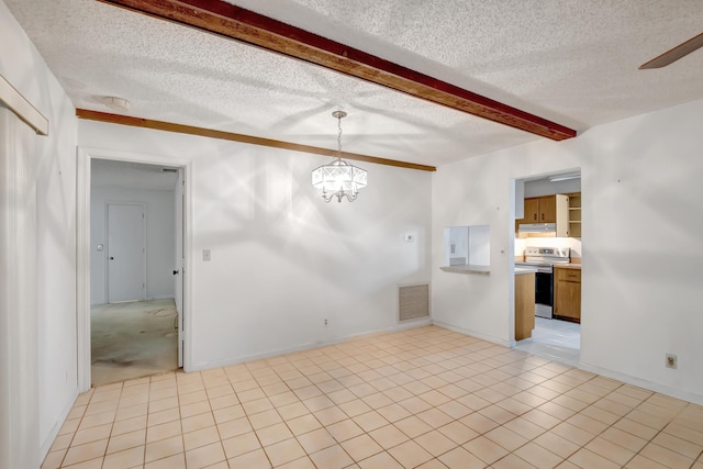 tiled spare room with a textured ceiling, beamed ceiling, and a notable chandelier