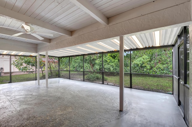 unfurnished sunroom with ceiling fan and beam ceiling