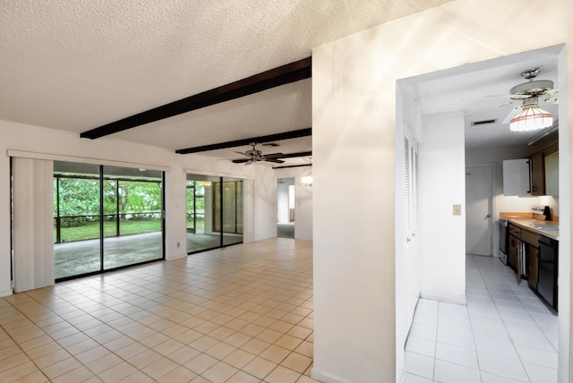 empty room featuring ceiling fan, beamed ceiling, a textured ceiling, and light tile patterned flooring