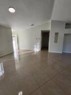 spare room featuring dark tile patterned floors