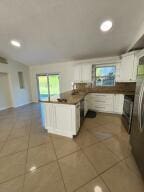 kitchen with white cabinets and dark tile patterned flooring