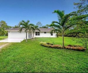 ranch-style house featuring a garage and a front yard