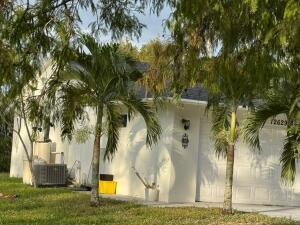 exterior space with central AC and a lawn