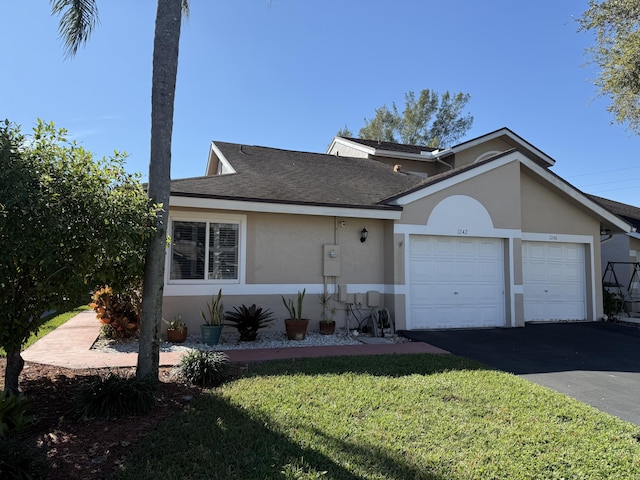 view of front of home with a front yard and a garage