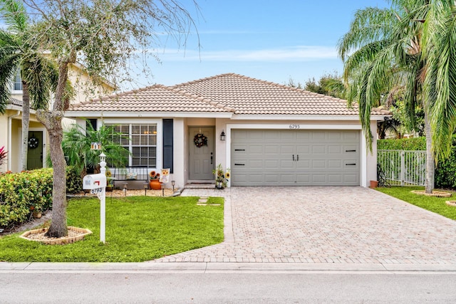 view of front of home with a front lawn and a garage