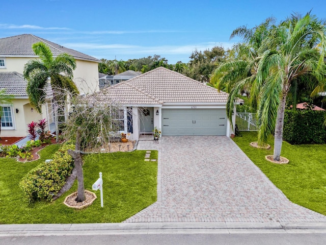 view of front of property featuring a garage and a front yard