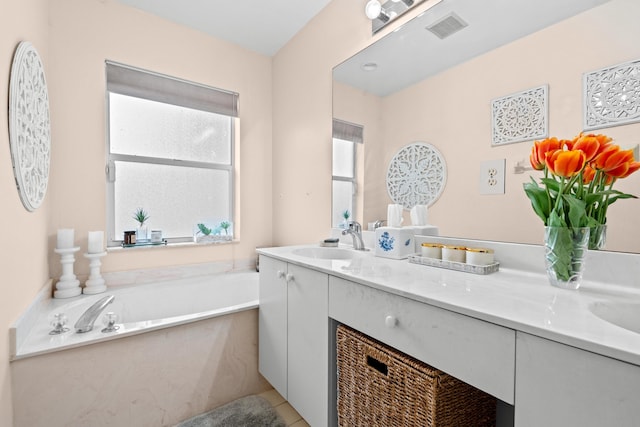 bathroom featuring a tub, plenty of natural light, and vanity