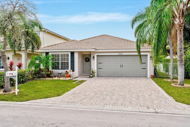 view of front of property with a garage and a front yard