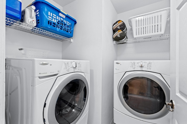 clothes washing area with washer and clothes dryer