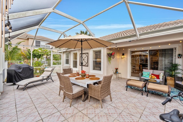 view of patio / terrace with a lanai and grilling area